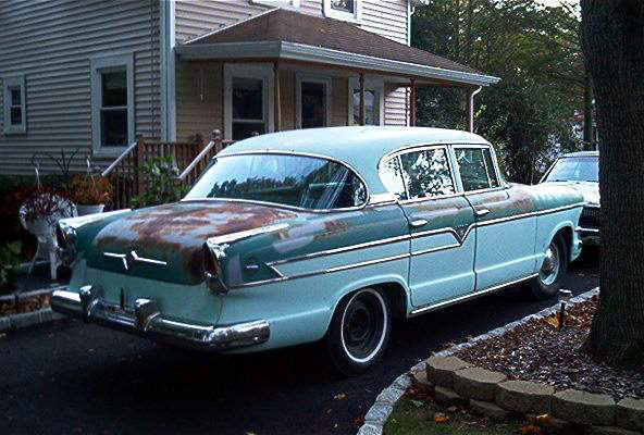 Rear quarter rust detail — Hudson in driveway during disassembly